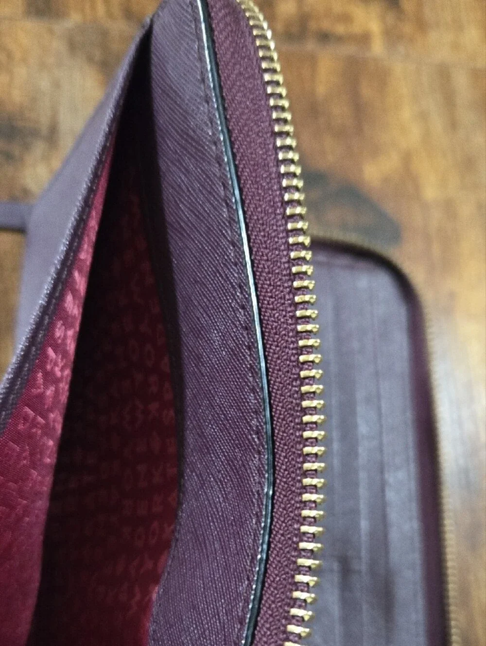 kate spade deep plum Saffiano zip-around leather wallet